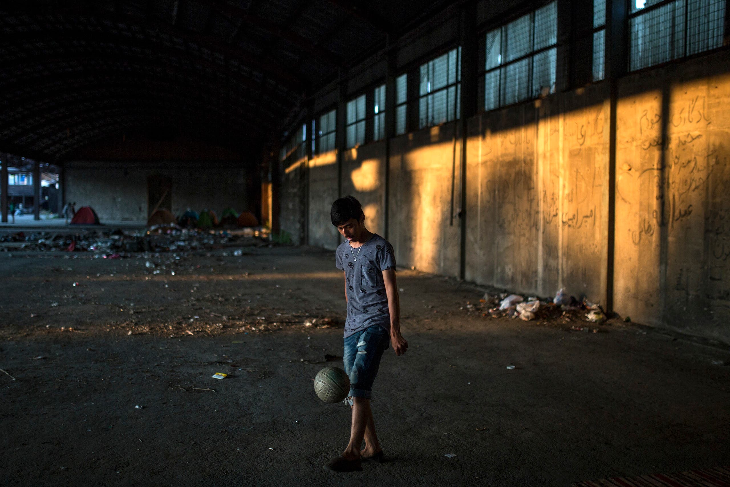 Migrants find shelter in an abandoned factory in Greece 