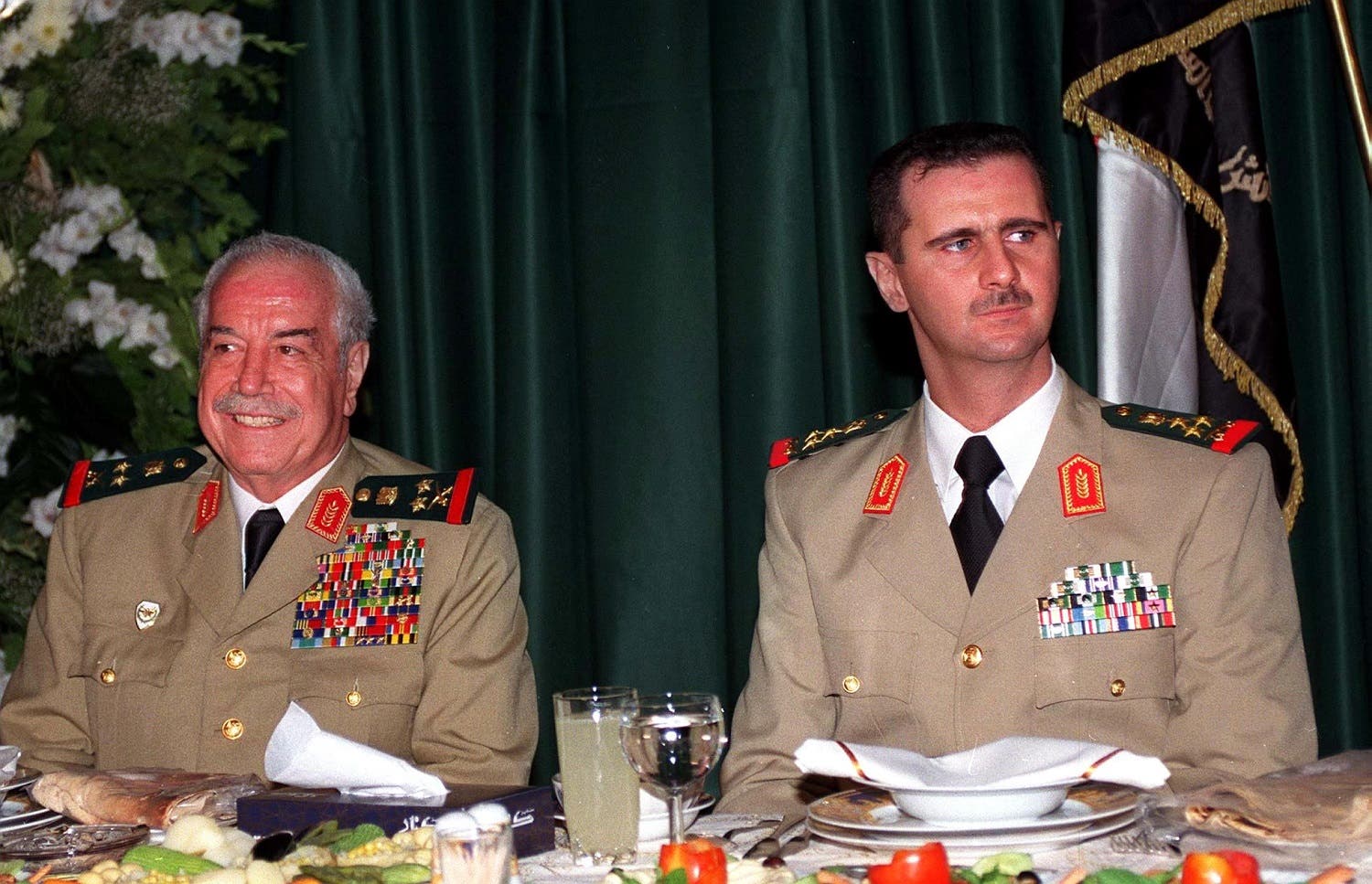 This handout file picture released on August 02, 2000 by the official Syrian News Agency (SANA) shows then Defence Minister Mustafa Tlass and Syrian President Bashar al-Assad (R) during a dinner in Damascus to marking the Army Day. Mustapha Tlass died at a hospital in Paris on June 27, 2017 at the age of 85, his son told AFP. (AFP)