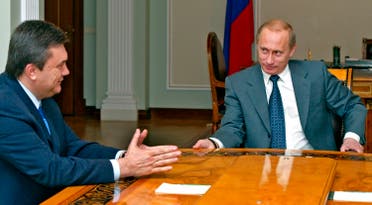 Vladimir Putin and Viktor Yanukovich during their meeting in the Novo-Ogaryovo residence outside Moscow, in this April 1, 2004 file photo. (AP)