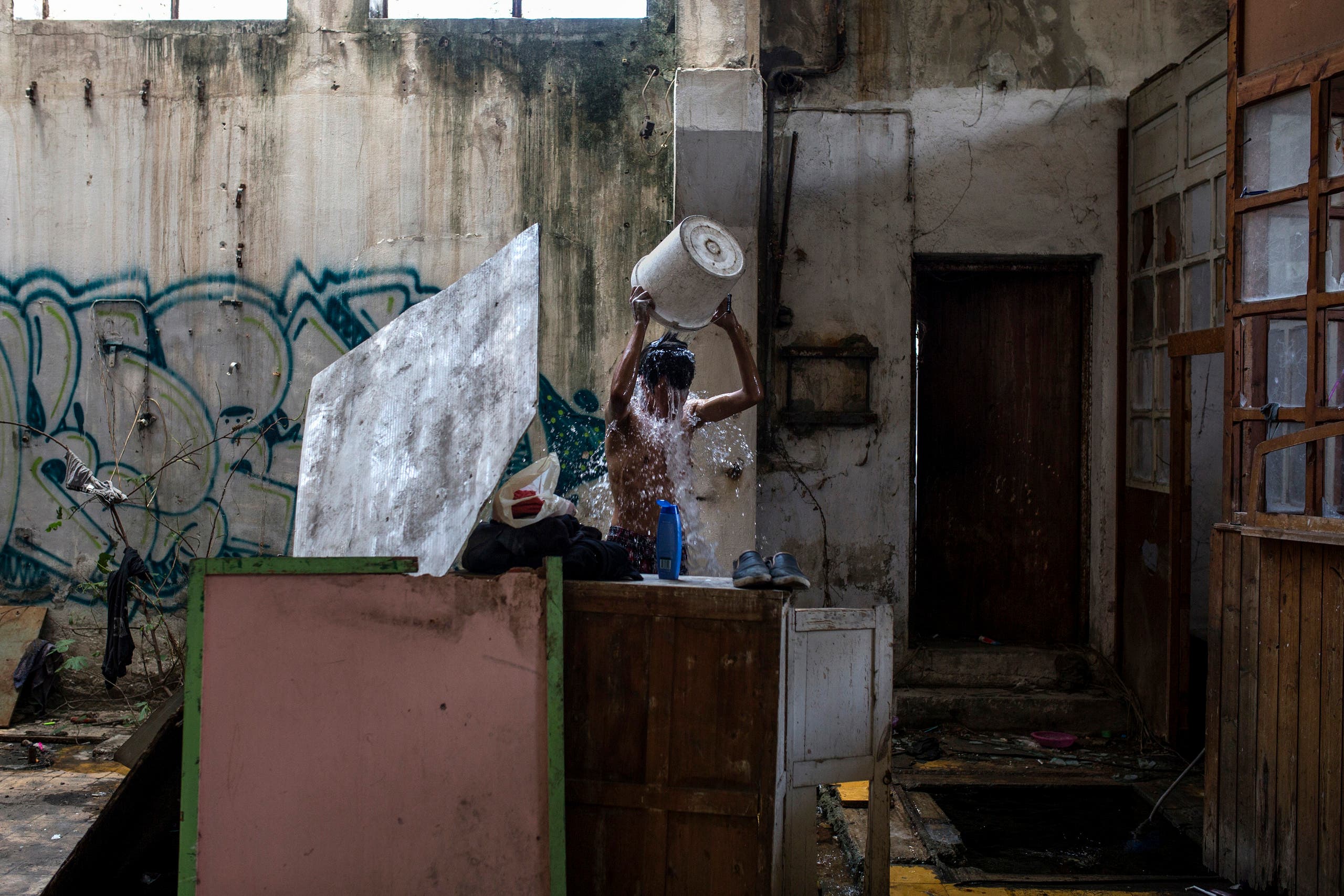 Migrants find shelter in an abandoned factory in Greece 