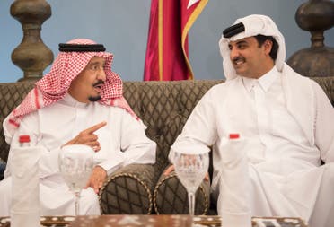 A handout picture provided by the Saudi Royal Palace on December 6, 2016 shows Saudi King Salman (L) chatting with Emir of Qatar Sheikh Tamim bin Hamad al-Thani in Doha before heading to Bahrain to attend a Gulf Cooperation Council (GCC) summit. (AFP)