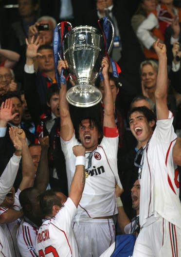 AC Milan's defender Paolo Maldini (C) holds the trophy near AC Milan's Brazilian midfielder Kaka after winning the Champions League football final match against Liverpool, at the Olympic Stadium, in Athens, 23 May 2007. AC Milan won 2-1. AFP PHOTO / PAUL ELLIS