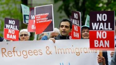 Pprotesters hold signs during a demonstration against President Donald Trump’s revised travel ban outside a federal courthouse in Seattle, on May 15, 2017.  (AP)