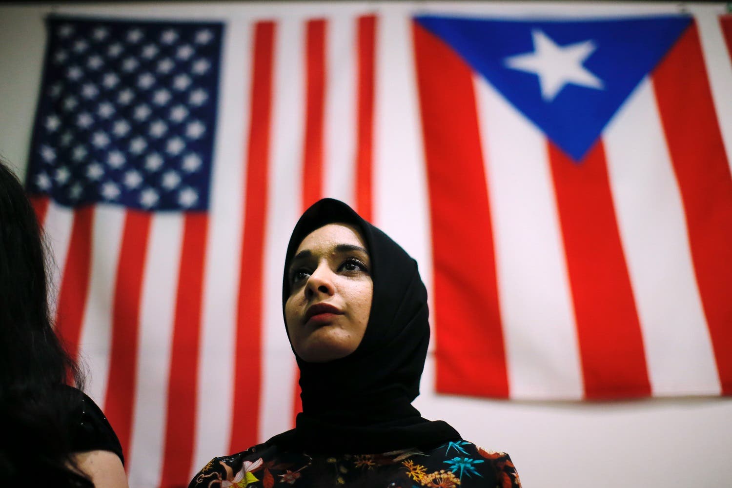 A woman attends a town hall meeting following a rally to protest restrictive guidelines issued by the US on who qualifies as a close familial relationship under the Supreme Court order on the Muslim and refugee ban at Union Square on June 29, 2017, in New York. (AFP)