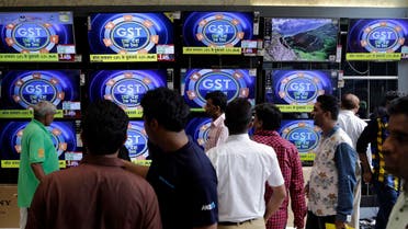 People look at televisions inside an electronics shop, a day ahead of the implementation of the nationwide Goods and Services Tax (GST) in Mumbai, on June 30, 2017. (AP)