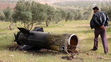 A man inspects a piece of a rocket that landed south of Daraa Al-Balad, Syria, April 5, 2017. (Reuters)
