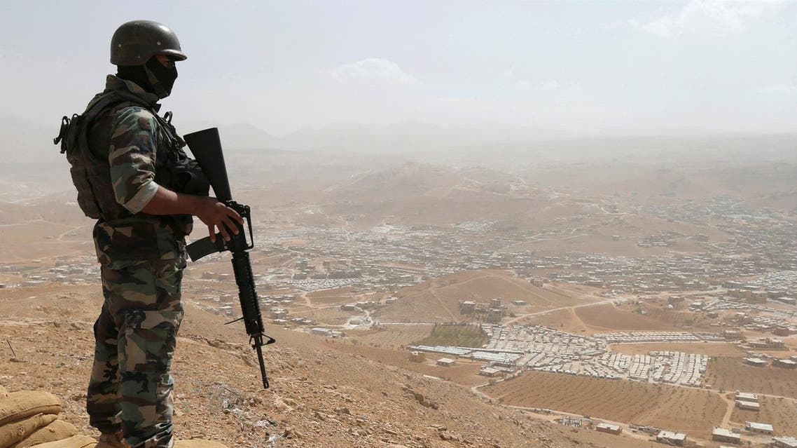 A Lebanese soldier carries his weapon as he stands on sandbags at an army post in the hills above the Lebanese town of Arsal, near the border with Syria, Lebanon September 21, 2016. Picture taken September 21, 2016. REUTERS/Mohamed Azakir TPX IMAGES OF THE DAY