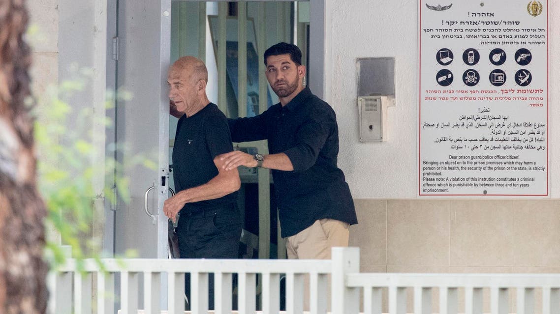 Former Israeli Prime Minister Ehud Olmert (L), 71, leaves the Maasyahu prison, on July 2, 2017 in Ramla. (AFP)