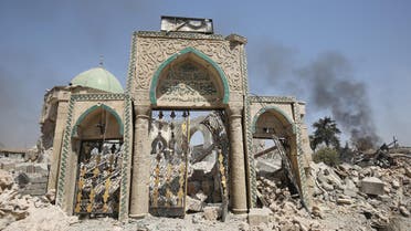 A picture taken on June 30, 2017, shows the destroyed gate of the Al-Nuri Mosque in the Old City of Mosul, as Iraqi government forces continue their offensive to retake the city from Islamic State (IS) group jihadists. IS blew up the mosque and the famed Al-Hadba (hunchback) leaning minaret on June 21 as Iraqi forces closed in. AHMAD AL-RUBAYE / AFP