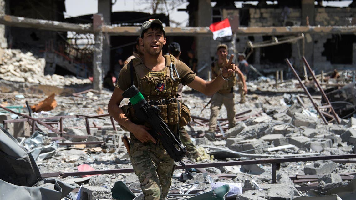 Members of Iraq's elite Rapid Response Division gesture as they patrol the Shifa neighbourhood, on the west bank of Mosul, on July 1, 2017. (AFP)