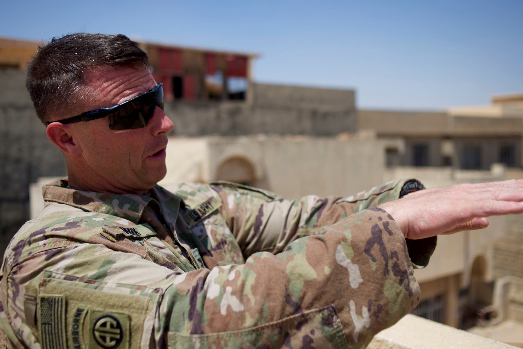 Colonel Pat Work of the U.S. Army's 82nd airborne division looks at the skyline, as he meets with Iraqi commanders near the front lines, on the rooftop of a house in Mosul, Friday, June 30, 2017. (AP)
