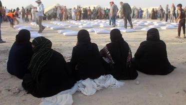 Iraqi women displaced from Ramadi, sit and wait to receive aid from the International Committee of the Red Cross (ICRC) at a makeshift camp where they are taking shelter in Habbaniyah, just east of the capital of Iraq's Anbar province. (AFP)