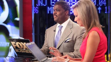 Hosts Charles Payne and Sandra Smith report on the stock market opening at FOX Studios on August 5, 2011 in New York City. (File photo: AFP)