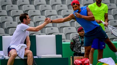 Andy Murray (L) shakes hands with Rafael Nadal after a training session at the Olympic Tennis Center in Rio de Janeiro on August 3, 2016. (AFP)