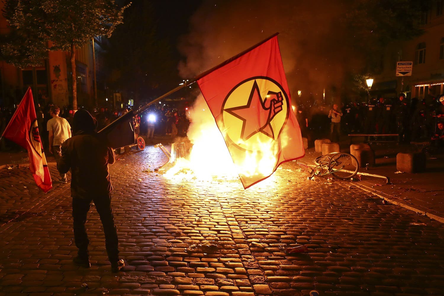 Protesters stand near a burning barricade during the demonstration during the G20 summit in Hamburg, Germany, on July 6, 2017. (Reuters)