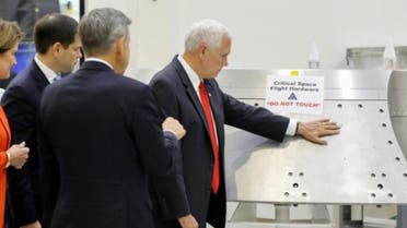  U.S. Vice President Mike Pence touches a piece of hardware with a warning label "Do Not Touch" at Kennedy Space Center in Florida Credit: Reuters 