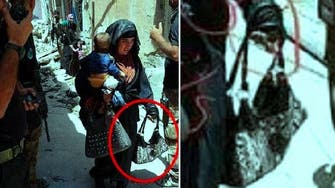 Images show female ISIS suicide bomber holding baby while pulling trigger