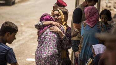 An Iraqi woman, who fled the fighting between government forces and ISIS militants in the Old City of Mosul, reacts while embracing another in the city’s western industrial district as they wait to be relocated, on July 8, 2017. (AFP)