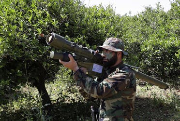 A Hezbollah fighter standing at attention near the town of Naqoura on the Lebanese-Israeli border. (File Photo: AFP)