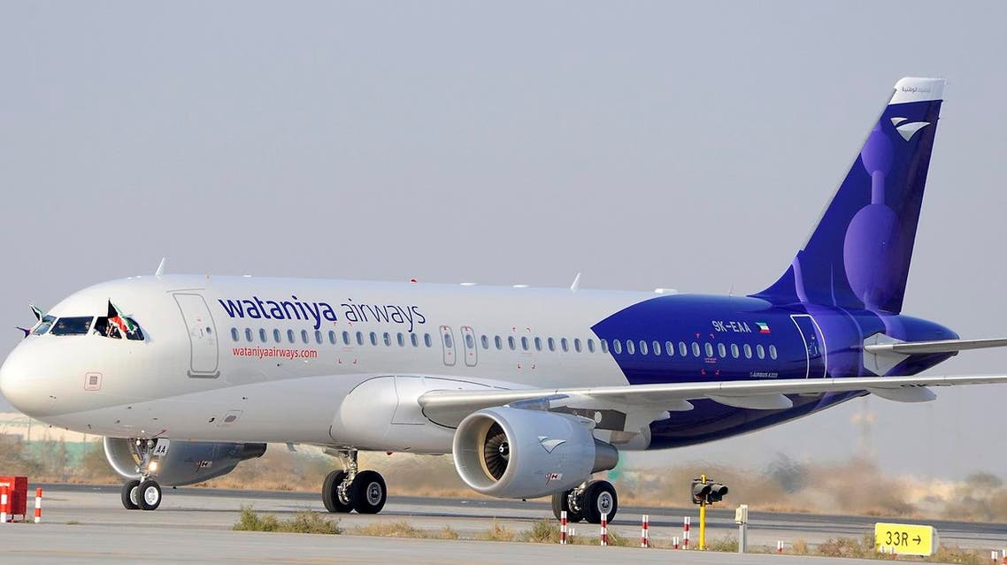 Wataniya Airways Captain Andrew Jamieson waves a Kuwaiti flag from the cockpit after landing the first A320 Airbus plane on the tarmac in Kuwait’s Sheikh Saad Terminal January 21, 2009. (Reuters)