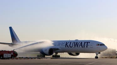 Airport officials spray water on the first Boeing 777-300ER ordered by Kuwait Airways after it landed at Kuwait International Airport on December 9, 2016, in Kuwait City. 