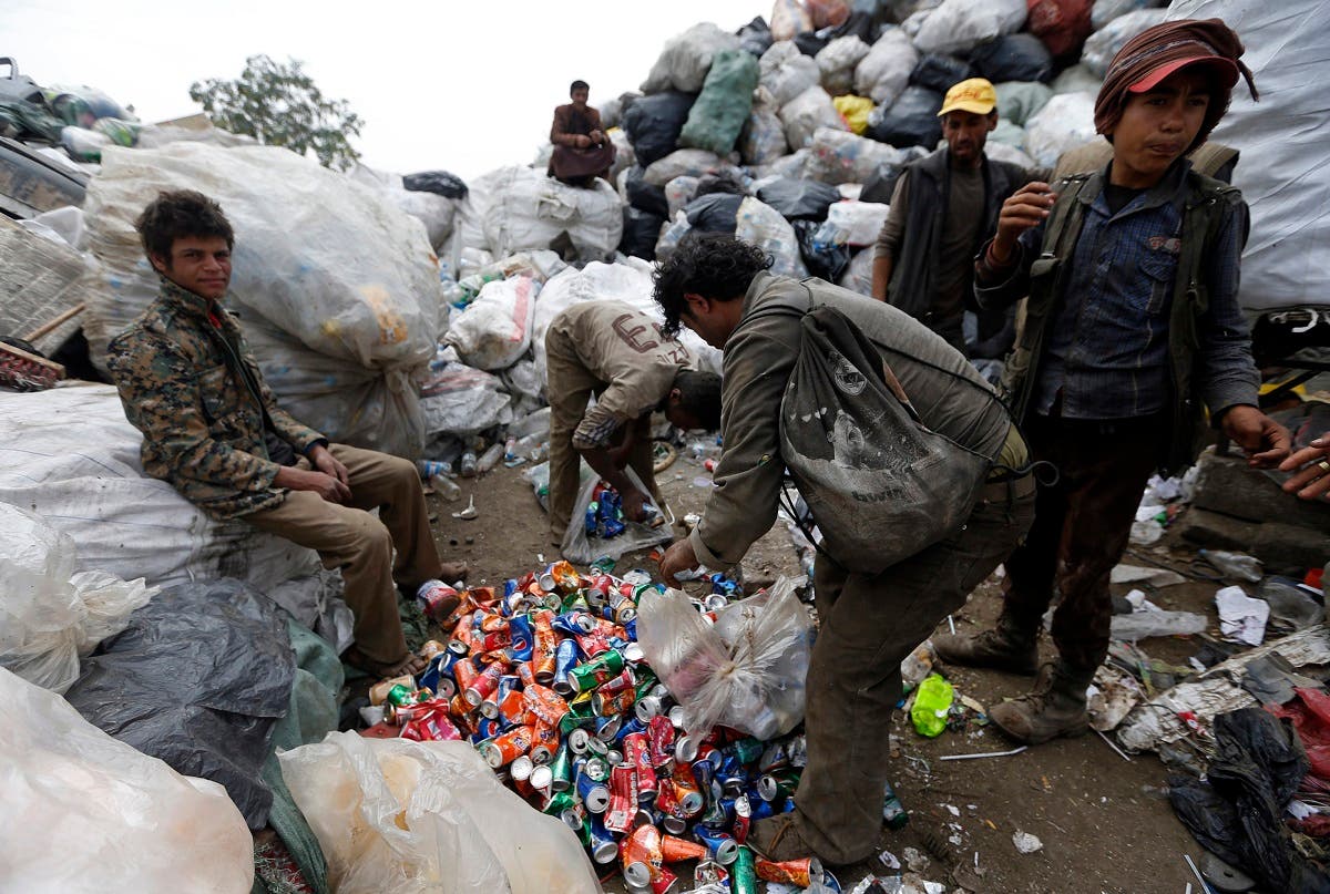Yemeni men scavenge for recyclable items at a garbage dump on the outskirts of Sanaa. (AFP)