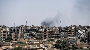 Damaged buildings are seen in western Raqa on July 12, 2017, during an offensive by Syrian Democratic Forces (SDF), an alliance of Kurdish and Arab fighters, to retake the city from Islamic State (IS) group fighters. The US-backed coalition has captured around 30 percent of Raqa city since it entered the IS bastion in June after a months-long operation to capture territory in the surrounding province. (AFP)
