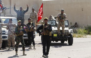 Hashid Shaabi (Popular Mobilisation) allied with Iraqi forces carry their weapons as they prepare to attack Tikrit in the Iraqi town of Ouja on March 26, 2015. (Reuters)