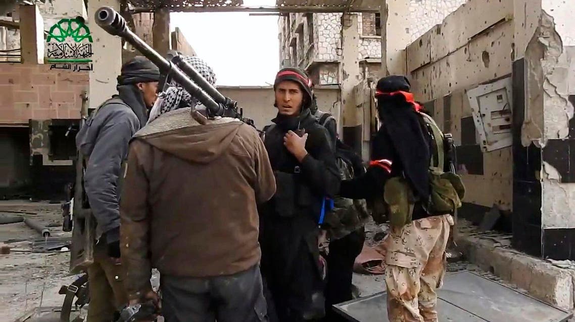 This frame grab from video provided on Tuesday March 21, 2017, by Ahrar al-Sham, Syrian militant group outlet that is consistent with independent AP reporting, shows fighters from Ahrar al-Sham militant group gather during a battle against Syrian government forces, in an eastern neighborhood of Damascus, Syria. Syrian government forces launched a counter-attack against rebels in Damascus on Tuesday, following a rebel suicide car bombing and another insurgent assault earlier in the day in the country's capital, media reports said. (Ahrar al-Sham, Syrian militant group, via AP)