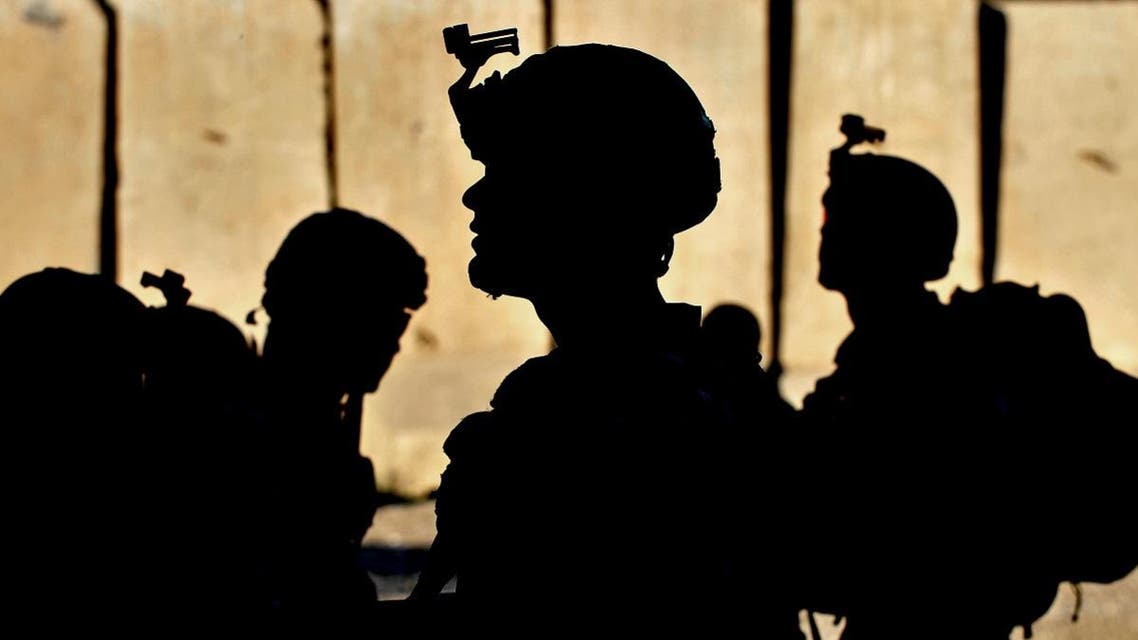 US army soldiers wait for orders at the Forward Base Honaker Miracle at Watahpur District in Kunar province prior to a joint patrol led by the Afghan National Army (ANA) to Operating Post Rocky to conduct artillery fire training with the Kandak 6/1 of the ANA on April 18, 2013. (AFP)