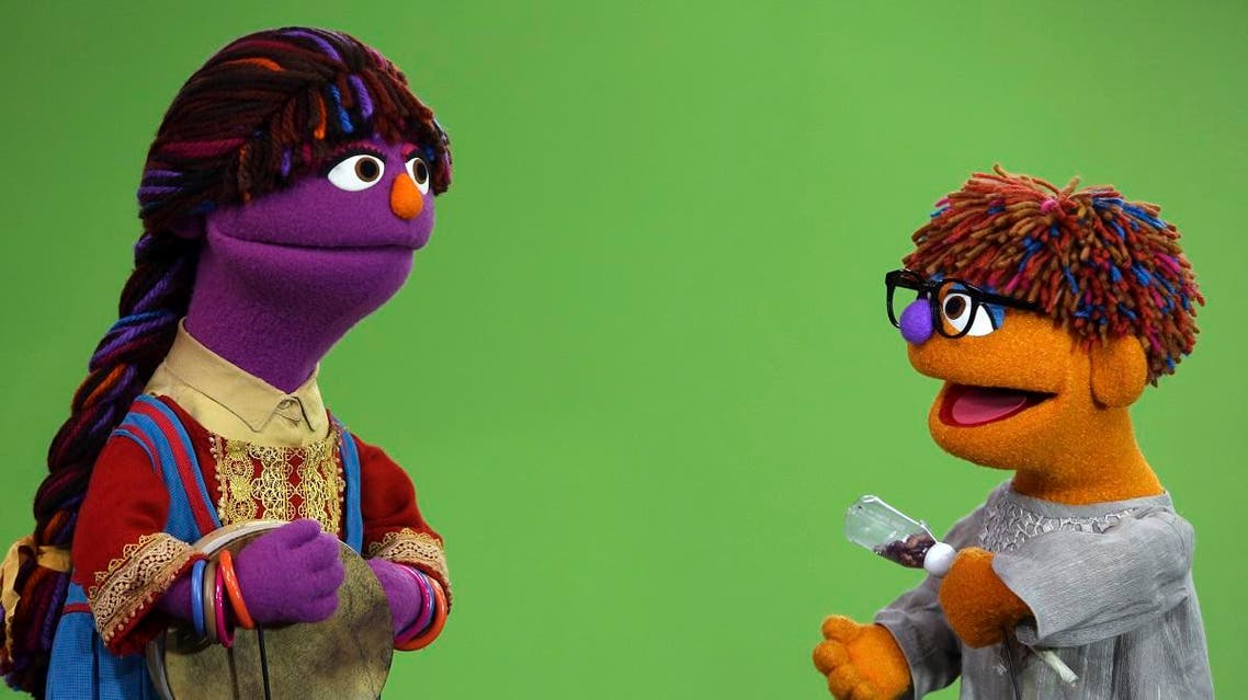 Sesame Street's new Afghan character, a 4-year-old Afghan puppet boy called Zeerak, right, and her sister, 6-year-old Zari, left, are seen during a recoding a segment for Afghan version of Sesame Street called Baghch-e-Simsim. (Rahmat Gul/AP)