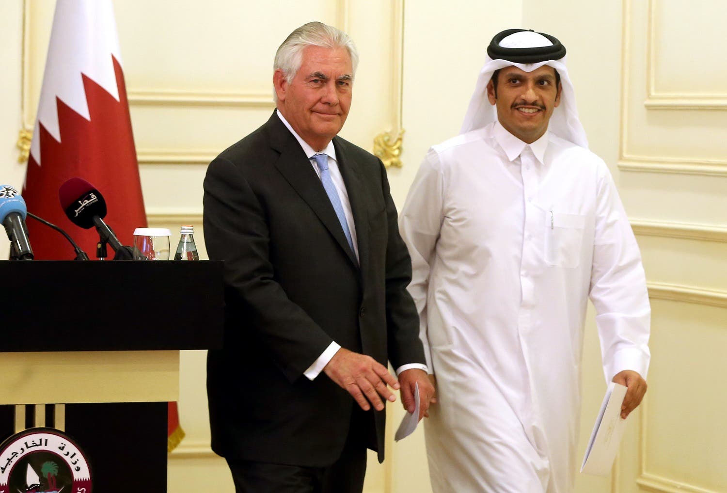 Rex Tillerson and Sheikh Mohammed bin Abdulrahman Al-Thani leave the stage following a press conference in Doha, on July 11, 2017. (AFP)