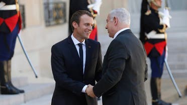 French President Emmanuel Macron (L) welcomes Israeli Prime Minister Benjamin Netanyahu (R) at the Elysee Palace, in Paris, on July 16, 2017 ahead of their meeting. (AFP)