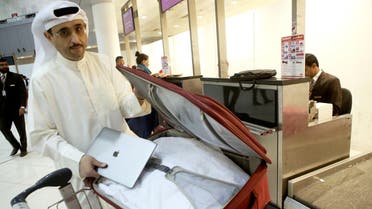 Kuwaiti social media activist Thamer al-Dakheel Bourashed puts his laptop inside his suitcase at Kuwait International Airport in Kuwait City before boarding a flight to the US on March 23, 2017. (AFP)