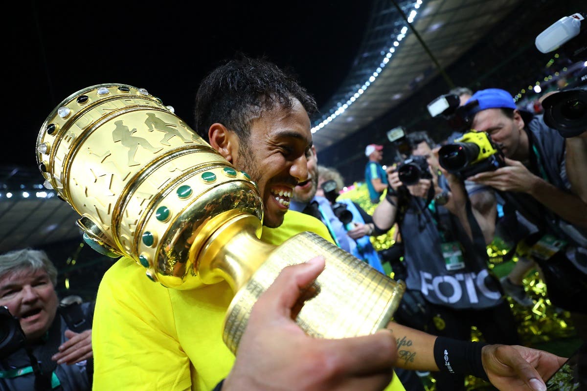 Borussia Dortmund's Pierre-Emerick Aubameyang celebrates winning the DFB-Pokal Final with the trophy. (Reuters)