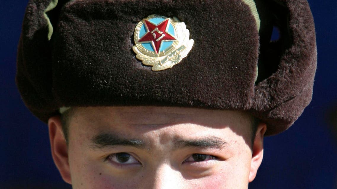 A Chinese soldier looks into the camera at the India-China trade route at Nathu-La, 55 km north of Gangtok, capital of India’s state of Sikkim, January 17, 2009. (Reuters)