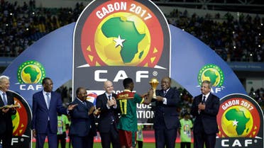 Issa Hayatou, President of the Confederation of African Football, hands the winner's trophy to Cameroon's Arnaud Djoum at the end of the African Cup of Nations final soccer match between Egypt and Cameroon at the Stade de l'Amitie, in Libreville, Gabon, Sunday, Feb. 5, 2017. (AP)