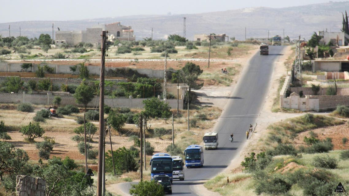 Syrian civilians and rebels, who were evacuated from the Qabun district in northeast Damascus, arrive by bus at a temporary camp in the northern countryside of Idlib province on May 15, 2017. (AFP)