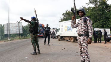 Ivory Coast's gendarmes and police officers stand guard in a street after clashes with former rebels on May 23, 2017 in Bouake. Reuters