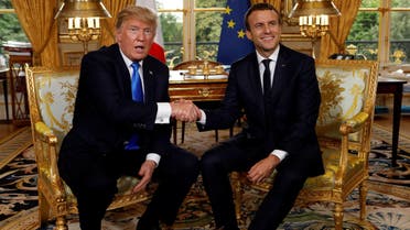 French President Emmanuel Macron and U.S. President Donald Trump (L) shake hands as they meet at the Elysee Palace in Paris, France, July 13, 2017