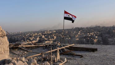A Syrian national flag flutters near a general view of eastern Aleppo after Syrian government soldiers took control of al-Sakhour neigborhood in Aleppo. (Reuters)