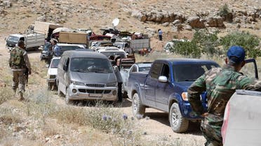 Hezbollah members escort a convoy of Syrian refugees at the border town of Arsal, Lebanon July 12, 2017. (Reuters)