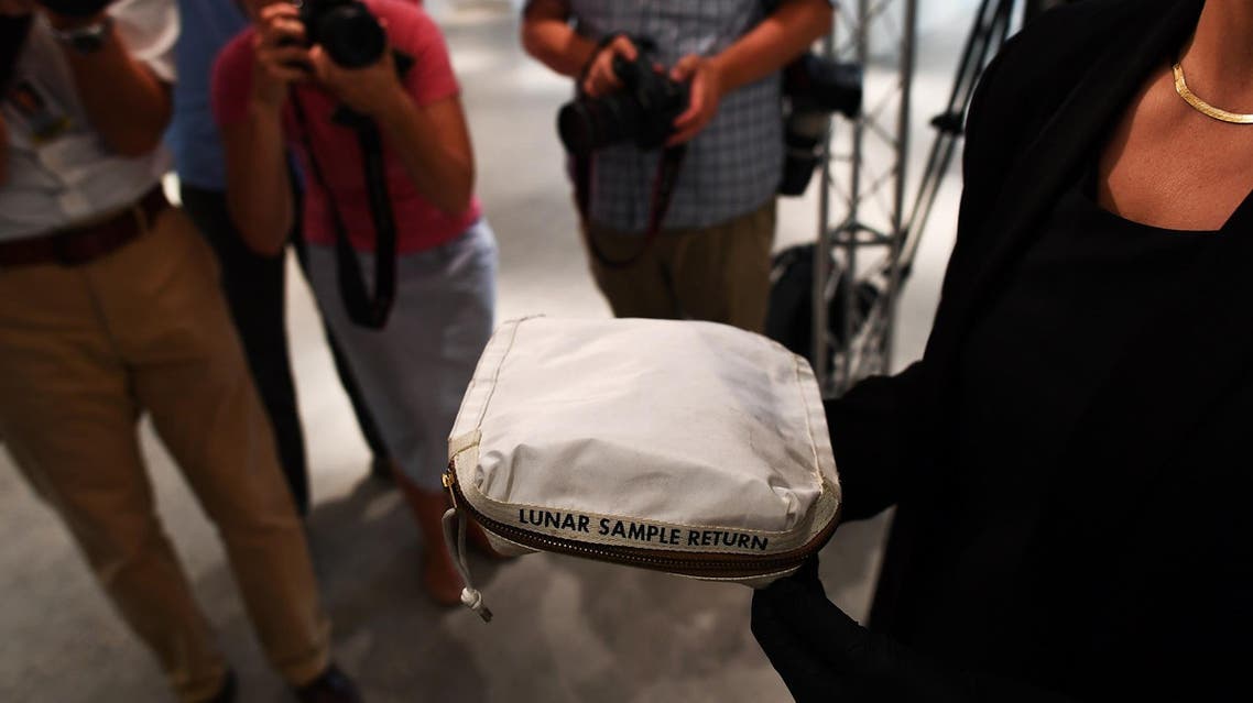 Sotheby’s Cassandra Hatton displays the Apollo 11 Contingency Lunar Sample Return Bag, used by Neil Armstrong on Apollo 11 to bring back the very first pieces of the moon ever collected, during a media preview for Space Exploration auction in New York on July 13, 2017. (AFP)