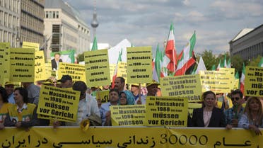 Activists hold banners during a demonstration against executions in Iran, in Berlin, Germany September 3, 2016. Banners in German read ‘The people who are responsible for the 1988 massacres in Iran need to be brought to court.’ (Reuters)