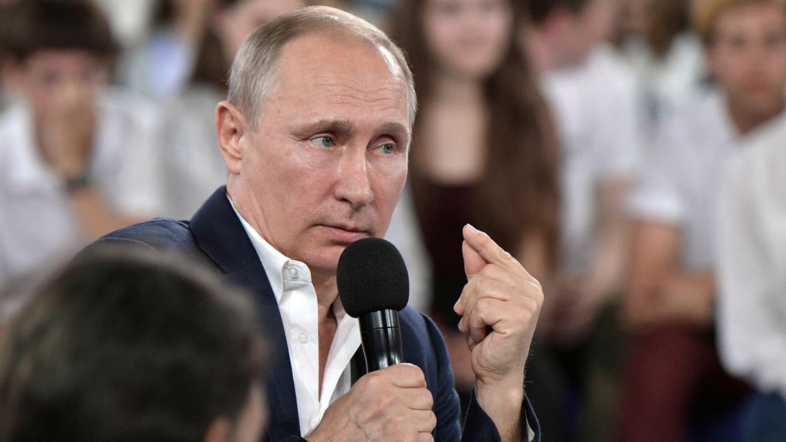 Russian President Vladimir Putin (R) speaks as he arrives during the "A Grown-up Conversation with Vladimir Putin" TV show held at the Sirius educational center for gifted children in Sochi on July 21, 2017.