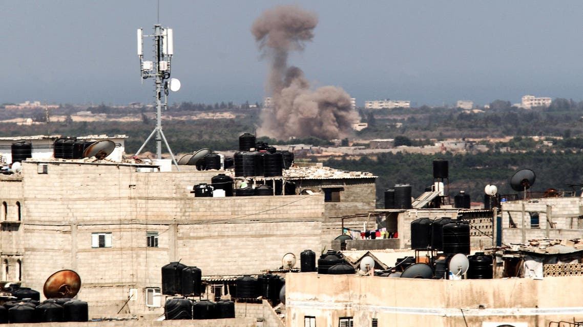 A picture taken from the Rafah border of the southern Gaza Strip with Egypt shows smoke billowing in Egypt's North Sinai on July 8, 2017. Twenty-six Egyptian soldiers were killed or wounded on July 7, 2017, in attacks on checkpoints in the Sinai Peninsula where the Islamic State group is conducting an insurgency, the military said.