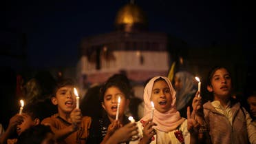 Palestinian children hold candles during a protest against Israel's newly-installed security measures at the entrance to the al-Aqsa mosque compound, in Khan Younis in the southern Gaza Strip July 23, 2017. REUTERS/Ibraheem Abu Mustafa