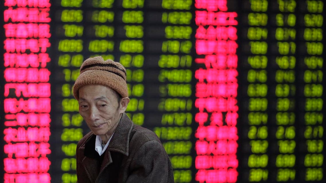 An investor looks at the stock price monitor at a private securities company in Shanghai, China, Thursday, Nov. 8, 2012. (AP)