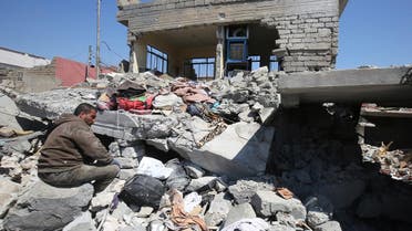 This file photo taken on March 26, 2017 shows an Iraqi man sitting amid the rubble of destroyed houses in Mosul’s al-Jadida area on March 26, 2017. (AFP)