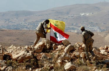 Hezbollah fighters put Lebanese and Hezbollah flags at Juroud Arsal, Syria-Lebanon border, on July 25, 2017. (Reuters)